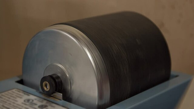 Barrel spinning as it is tumbling rocks as part of the lapidary finishing process.