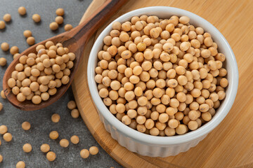 Bowl with soy beans. Detail of wooden spoon and bamboo support.