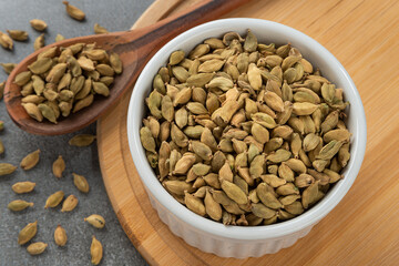 Bowl with grains cardamom. Detail of wooden spoon and bamboo holder.