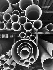Multi size pvc pipe on the metal rack in black and white