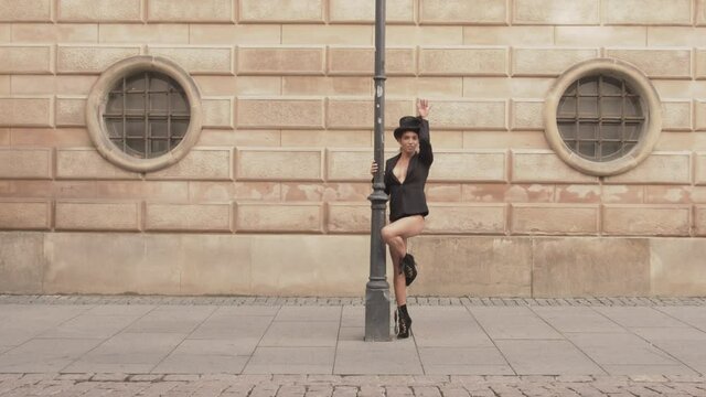 Dancer Moving And Posing In Top Hat Around Streetlight