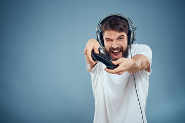 a man in a white t-shirt with a joystick in his hands game console entertainment emotions