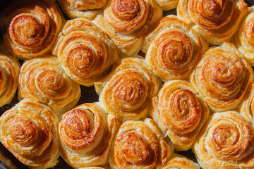 Freshly baked cinnabon buns. Rolls with cinnamon. Home baking.Flat closeup. Top view.Selective focus