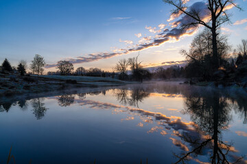 Fototapeta na wymiar Fog on a pond during sunrise in the Spring in a garden on a farm in Oregon