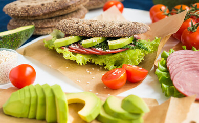 Homemade Sandwich. Rye bread with bran, Beef Ham, Avocado and Lettuce
