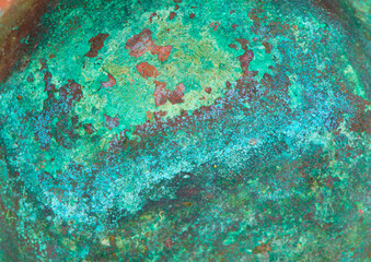 Fototapeta na wymiar Aged copper plate texture with green patina stains. Old worn metal background