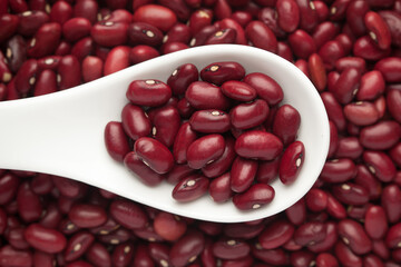 macro Close-up of Organic Rajma,  (Laal Lobia ) or red kidney beans dal on a white ceramic soup spoon. Top view