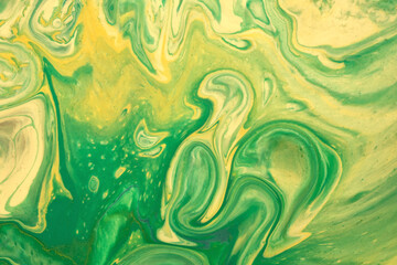Abstract fluid art background green and yellow colors. Liquid acrylic painting with emerald...
