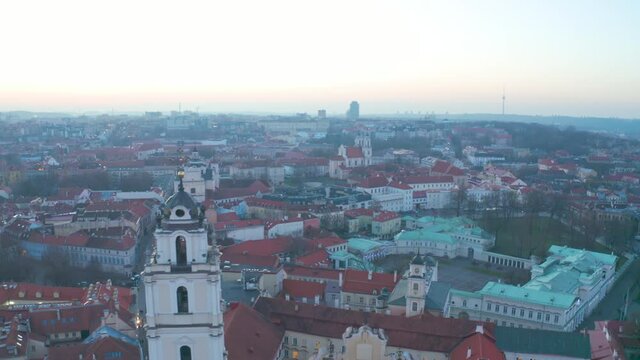 Flying over beautiful Old Town Vilnius and the amazing buildings. Aerial tilt down shot.