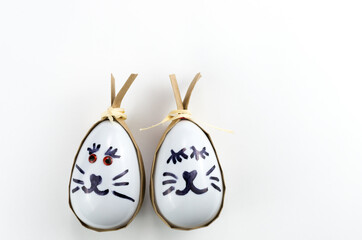 Happy easter bunny egg and eggs colored eggs  in a basket isolated on a trendy white background.