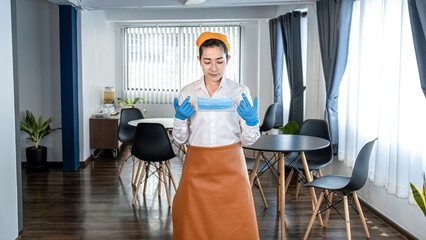 Asian woman waitress wearing face mask and medical glove to prevent and stop coronavirus before working