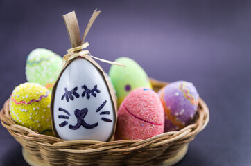 Happy easter bunny egg and eggs colored eggs  in a basket isolat