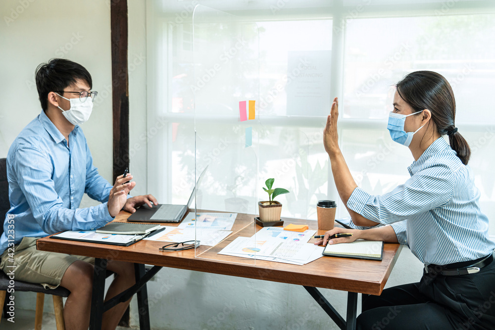 Poster two business colleagues wearing face mask to brainstorming business project and giving high five to 
