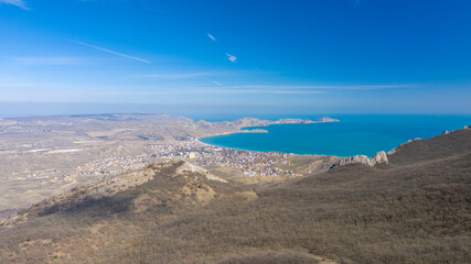Fototapeta na wymiar Coast of the Crimea peninsula, rocky mountains, aerial view of the sea resort of Koktebel