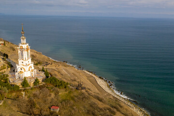 Fototapeta na wymiar Coast of the Crimea peninsula, rocky mountains, aerial view Temple-lighthouse of St. Nicholas the Wonderworker (Russia, Malorechenskoye)