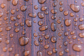 Raindrops on the metal profile sheet. Brown profiled metal sheet with dew drops.