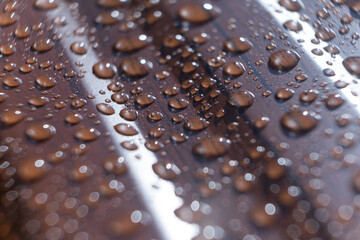 Raindrops on the metal profile sheet. Brown profiled metal sheet with dew drops.