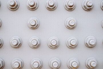 The texture: abstract background of bolts and nuts painted gray on