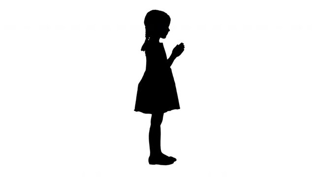 Silhouette Little girl in polka dot dress clapping her hands.