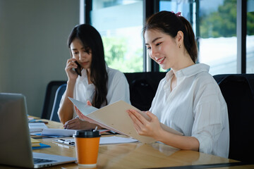 Two of Young business female working together and partners talking with customer.