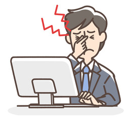 パソコンの業務で疲れ目のスーツの男性