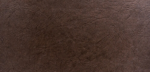 Abstract dark brown paper texture with leather-like embossing.