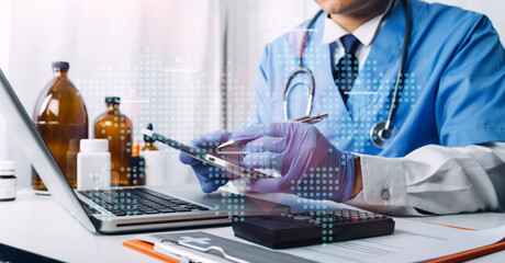 Medical technology concept The doctor works with mobile phones, headphones and tablets. Digital laptop Pressing the calculator in the modern office at the hospital in the morning