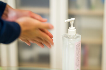 Coronavirus pandemic prevention for Covid-19: washing hands with Hand sanitiser alcohol gel rub