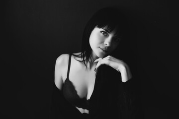 Obraz premium black and white portrait of a brunette girl in a black dress and lingerie