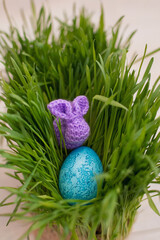 handmade bunny with egg in the green grass, easter