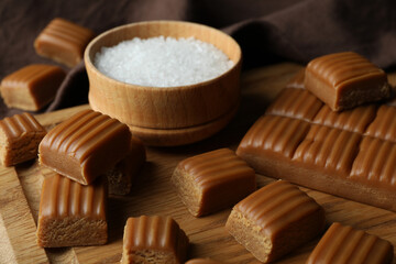 Kitchen towel and board with caramel pieces and sal, close up