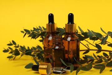 Concept of natural cosmetics with eucalyptus oil on yellow background