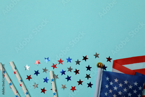 American flag, glitter and straws on blue background