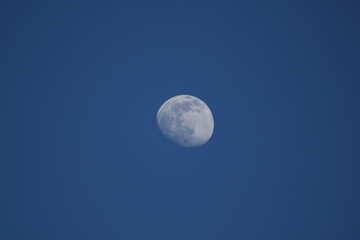 The full moon over blue sky