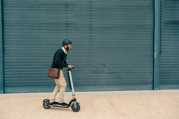 Man driving an electric scooter in the city wearing mask © noeliauroz