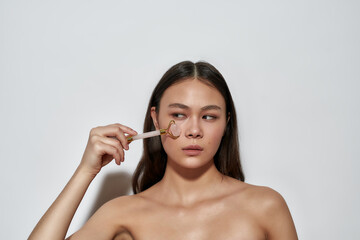 Fototapeta premium Girl looking to the side while taking care of skin