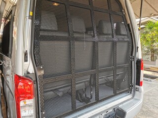 Behind the prisoner transport vehicle