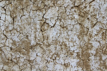 White Dirty Cracked Texture Background of Old Barn Clay Wall covered with Lime