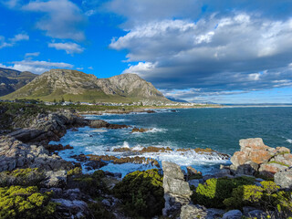 View of rocky coastline, Walker Bay  and Klienrivier Mountains from Sievers Point. Hermanus, Whale Coast, Overberg, Western Cape. South Africa