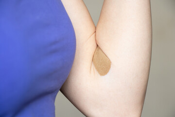 a plaster on the arm after taking blood from a vein