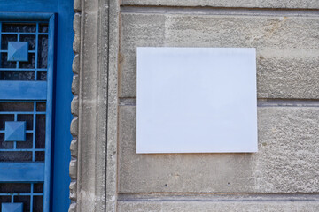empty white blank plate on the entrance signboard on textured wall mockup