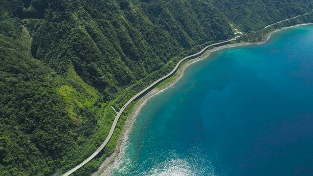 Long bridge with highway along the seashore. Viaduct in the coast of Highway with bridge by coast sea near the mountains.