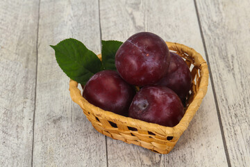 Plum heap in the wooden basket
