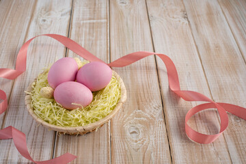 Easter eggs in a nest on a wooden background 