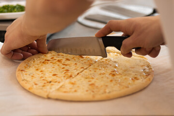 Cutting pizza with a knife