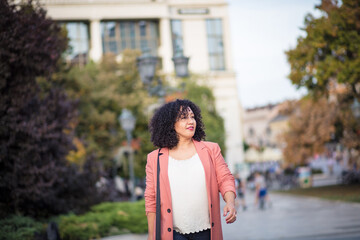 Business woman walking trough city alone.