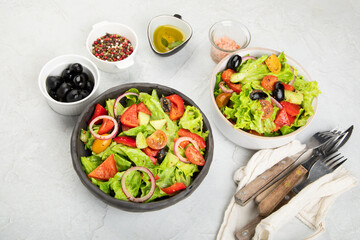 Fresh vegetables salad on light gray background. Healthy eating concept.