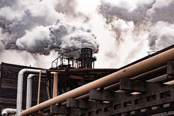 Thick smoke from metallurgical plant. pipes and production facilities. large environmental...