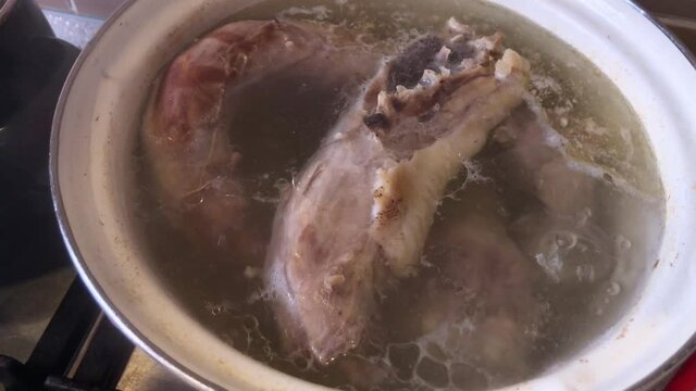 Boiled bouillon in enamel saucepan closeup