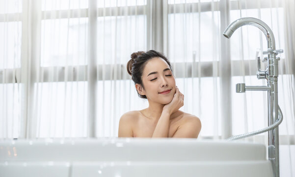 Portrait of young attractive happy asian girl takes a bath relax in the bathroom. Beauty woman in spa treatments. Healthy perfect glow skin care, Asia wellness spa concept